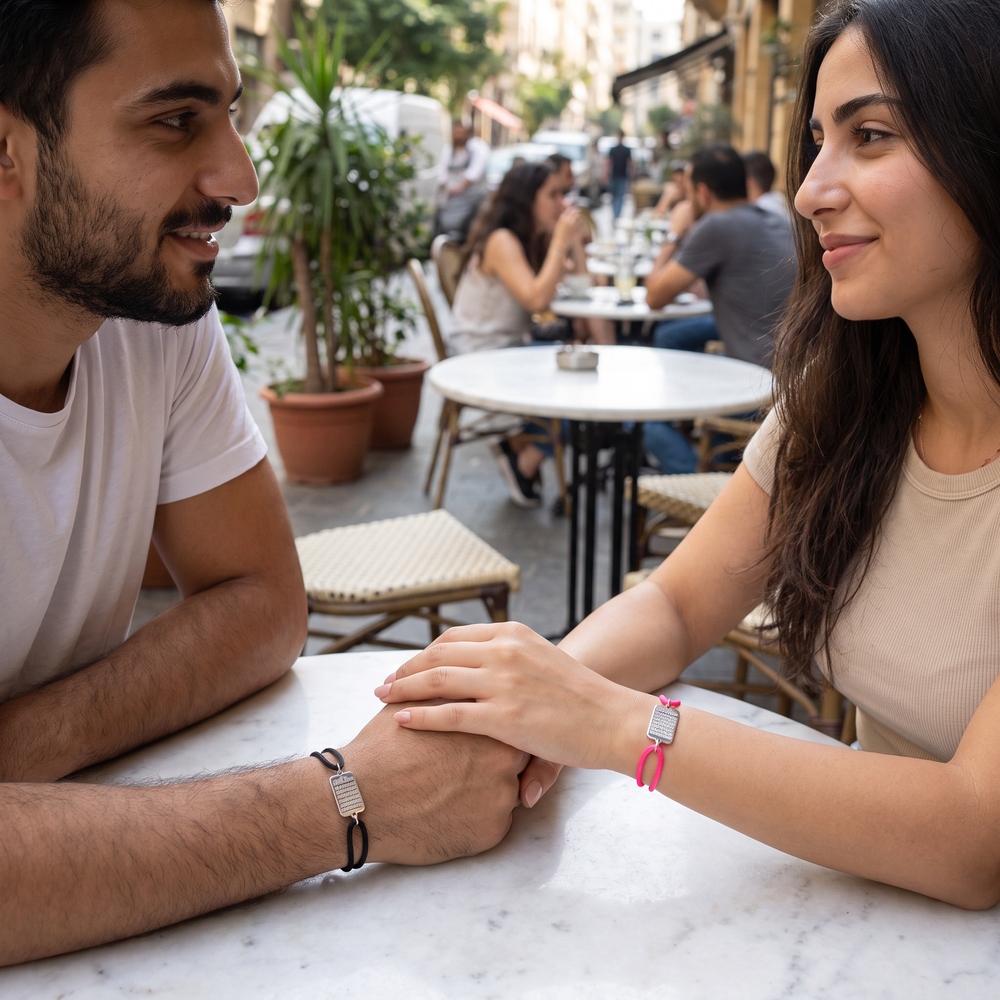 Couple wearing the Ayatul Kursi cord bracelet, black and neon pink cords