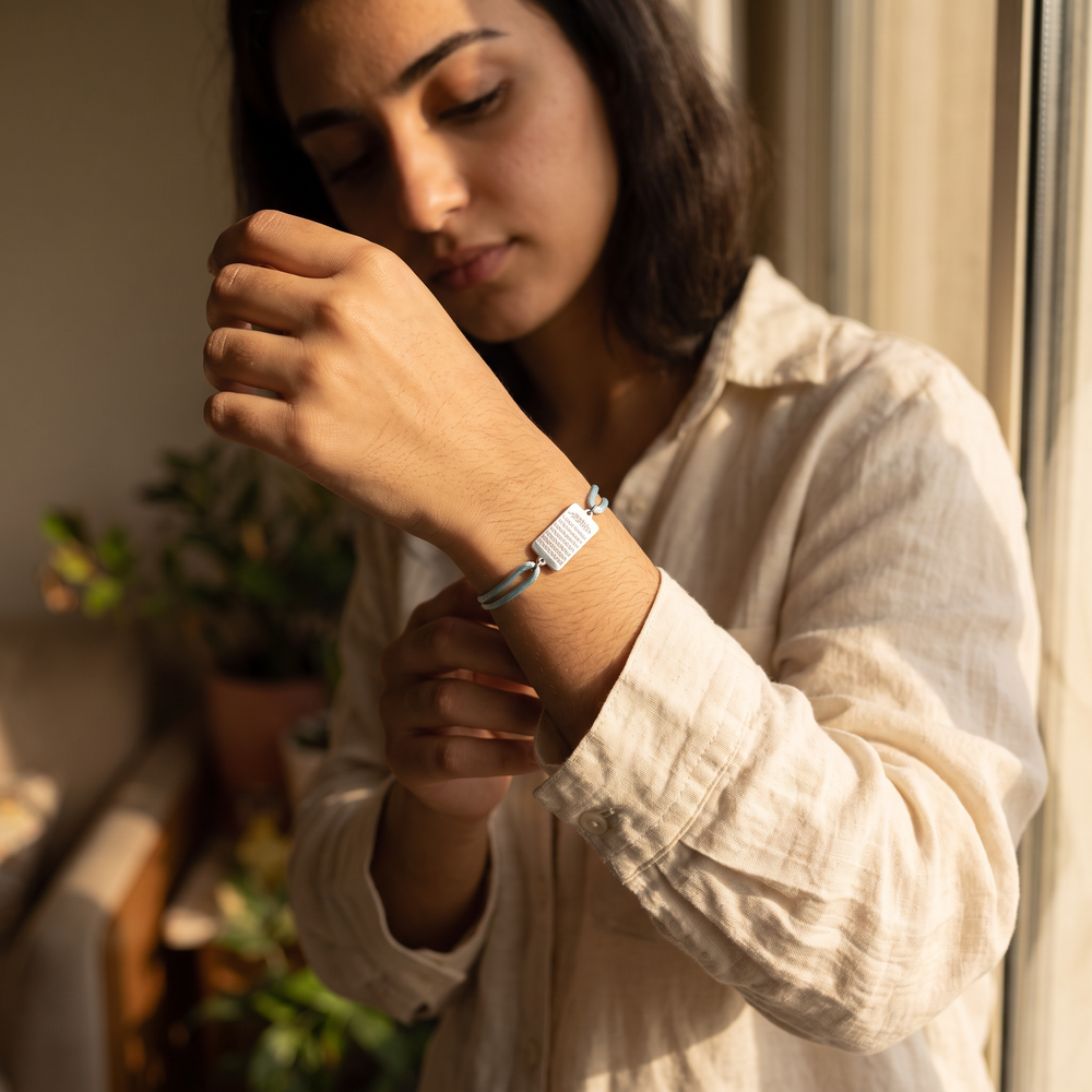 Woman wearing the Ayatul Kursi cord bracelet, light blue cord